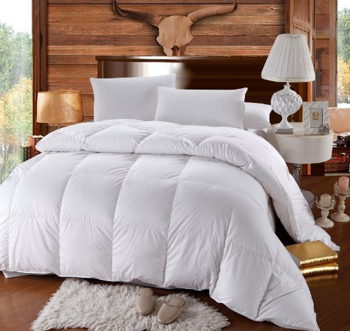 White Goose Feather and Down Duvet on a bed with wooden headboard and lamp 