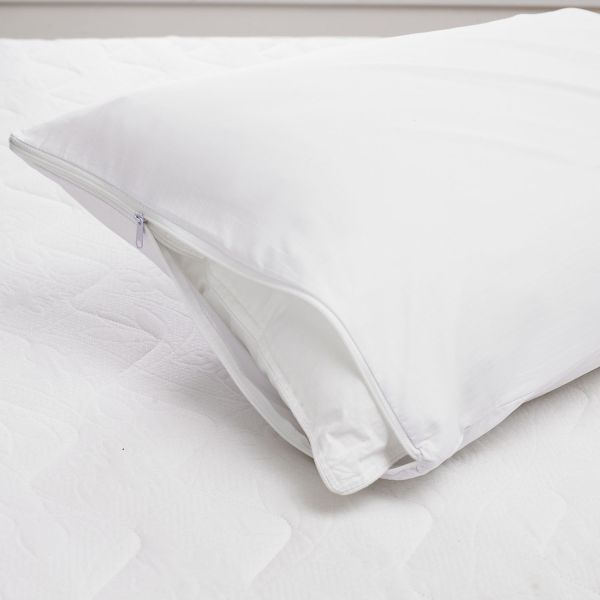 Zipped cotton pillow protector on a bed 